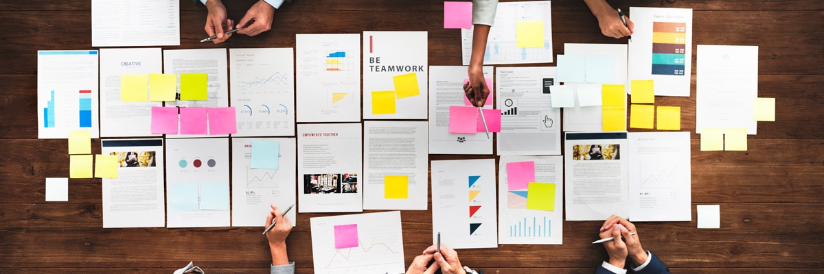 Papers on Wooden Table with Sticky Notes