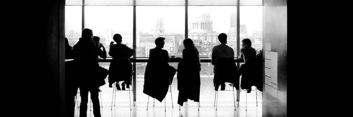 Silhouettes in Window with City in Background