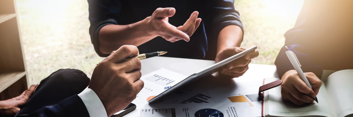 Hand Pointing to a Tablet Discussing Project