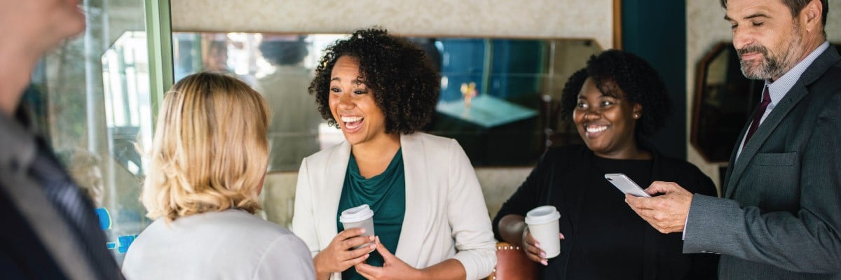 Group of Coworkers Laughing While Enjoying Coffee