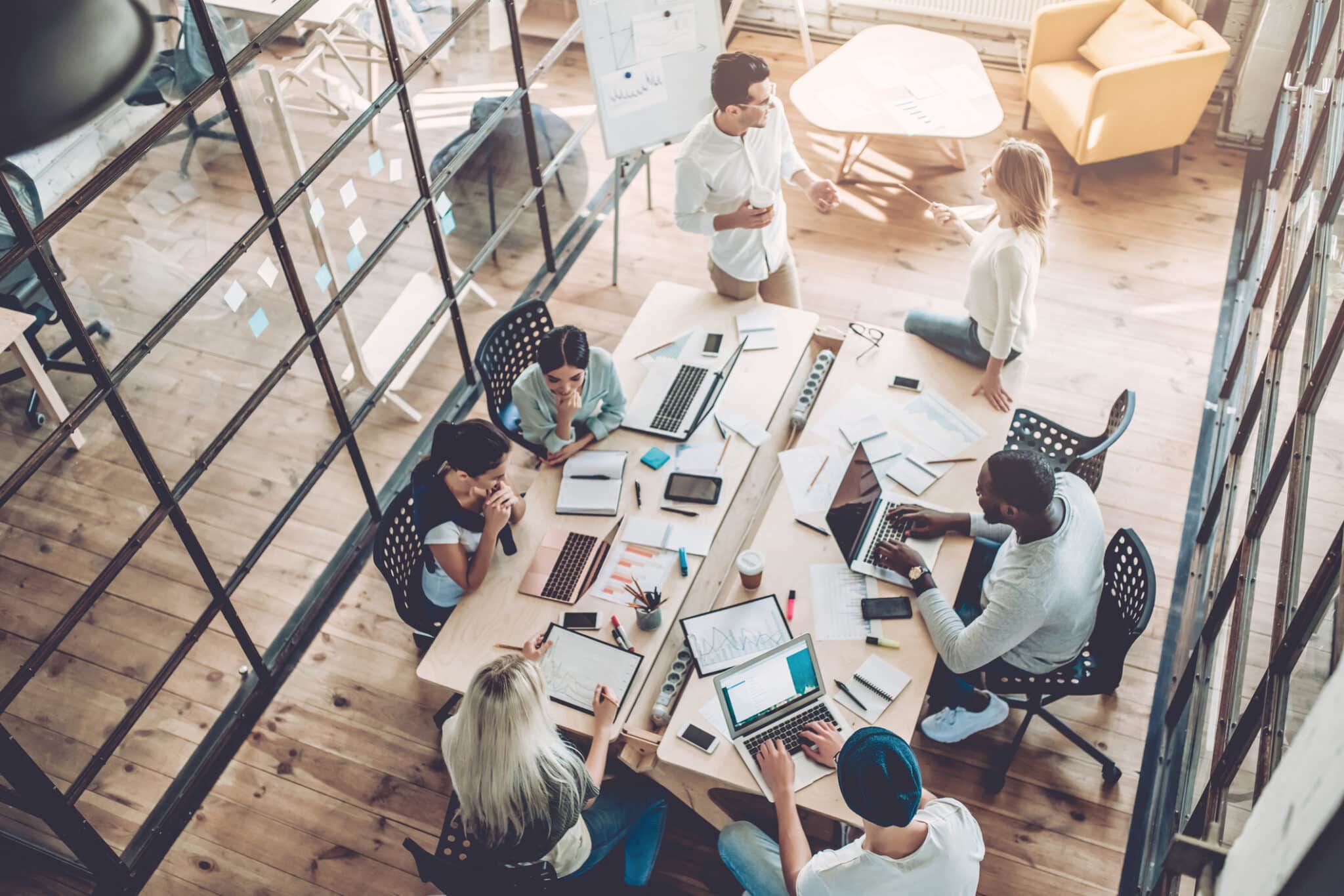 Team in Coworking Space At Desk Together