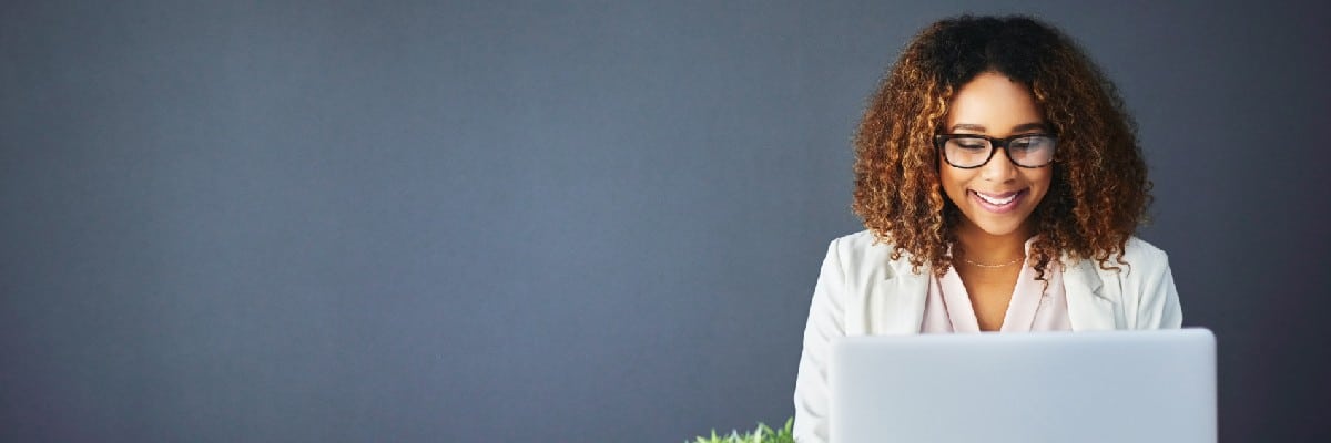 Happy Business Woman Working on Laptop