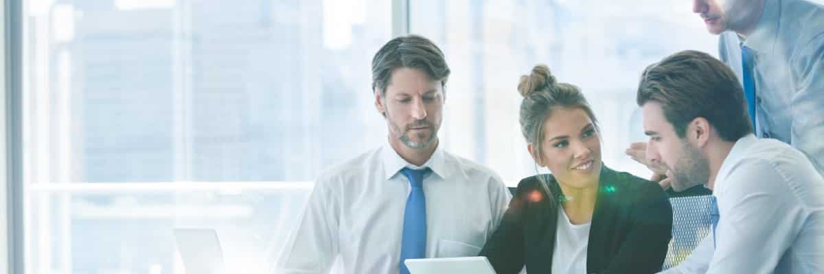 Employees Meeting around a Laptop Having a Discussion