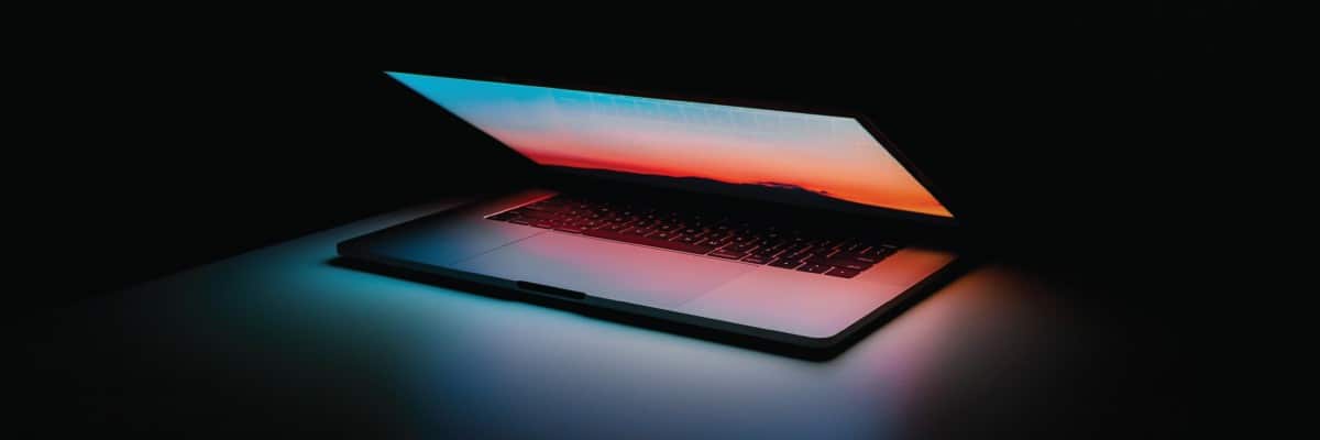 Laptop Partially Closed in Dark Room