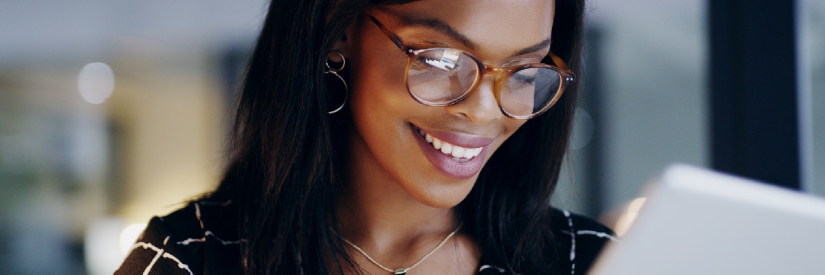 Woman Smiling While Looking At Phone