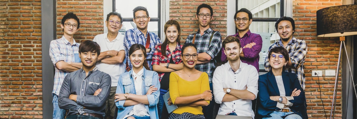Group of Young Employees Posing with Arms Crossed