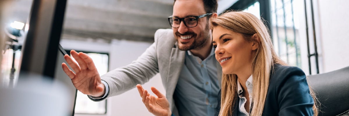 Man and Woman Talking and Pointing at Computer Screen