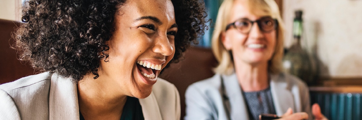 Woman Laughing with out of Focus Woman in Background