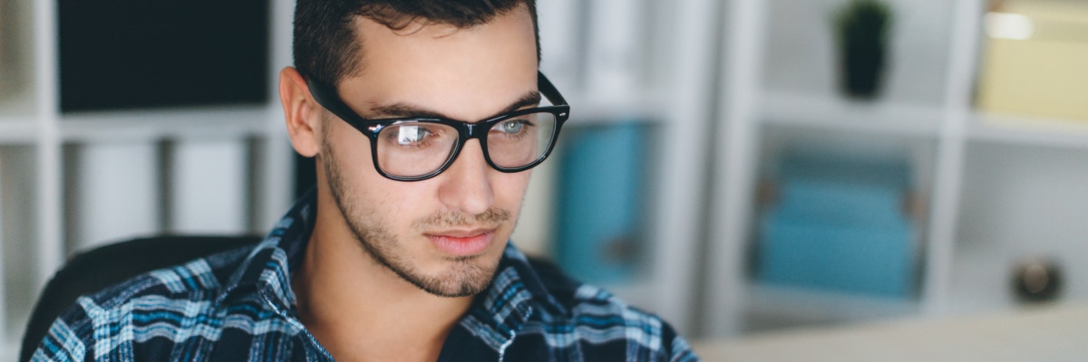 Man Looking at Computer with Concentration
