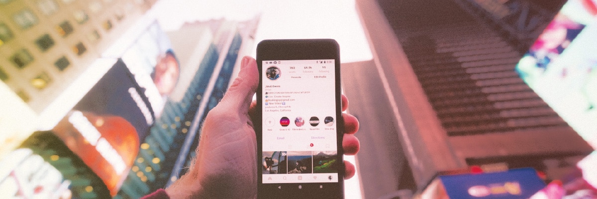 Hand Holding Smart Phone with Instagram Open