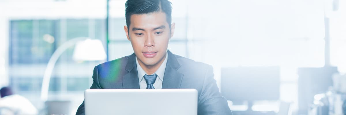 Front View of Business Man On Laptop