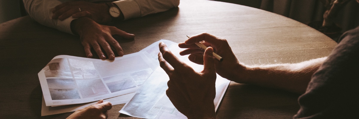 Hands Gesturing While Over Various Papers
