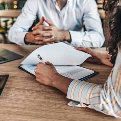 person signing contract before completing onboarding training