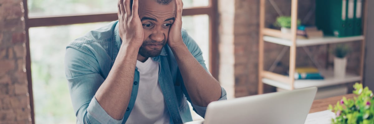 Man Looking Upset at His Computer