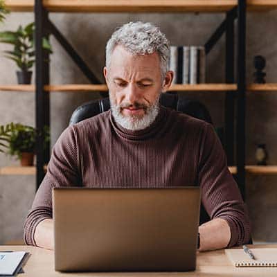 Person doing custom eLearning on a laptop