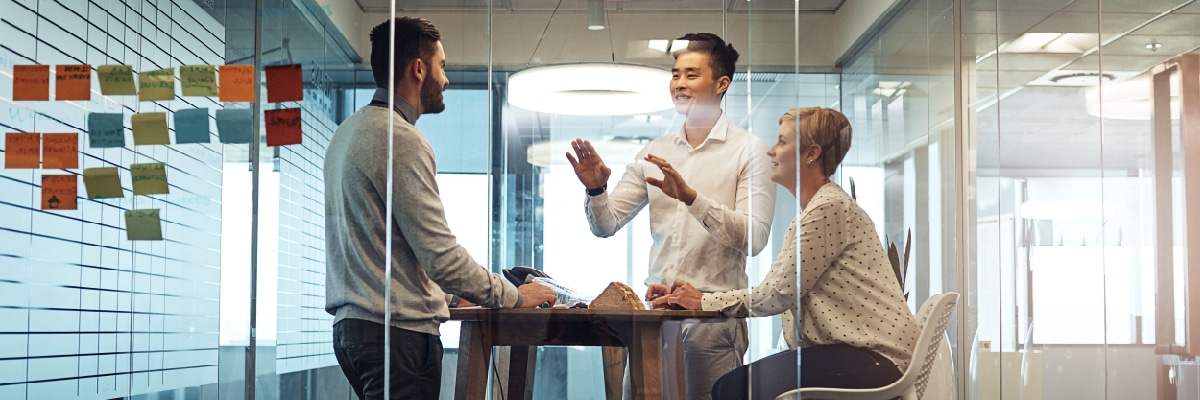 Employees Discussing Strategy in Small Meeting Room
