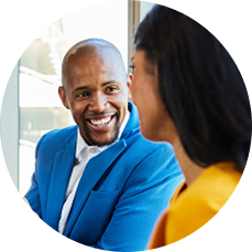 A man and a woman are engaged in a positive, close conversation.