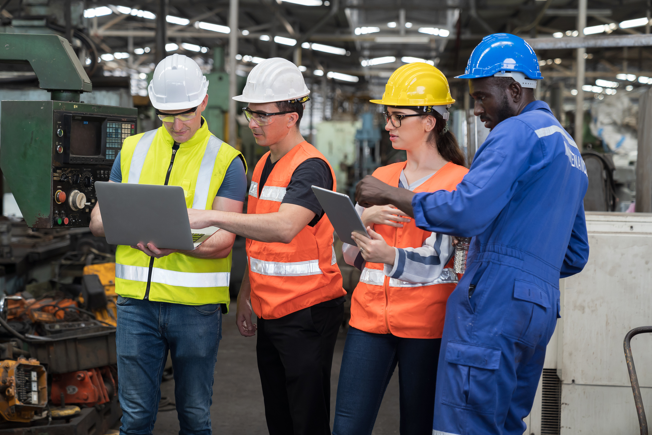 Frontline worker using a mobile device to complete job-specific training in a warehouse setting